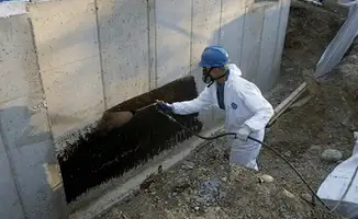 Professional waterproofing the exterior walls of the basement in Dallas, TX