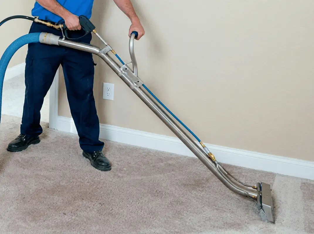 Professional operating a liquid removal machine on a carpeted floor in Dallas, TX